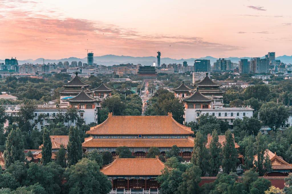 A beautiful cityscape of Beijing featuring historic temples at sunset, capturing the mix of tradition and modernity.