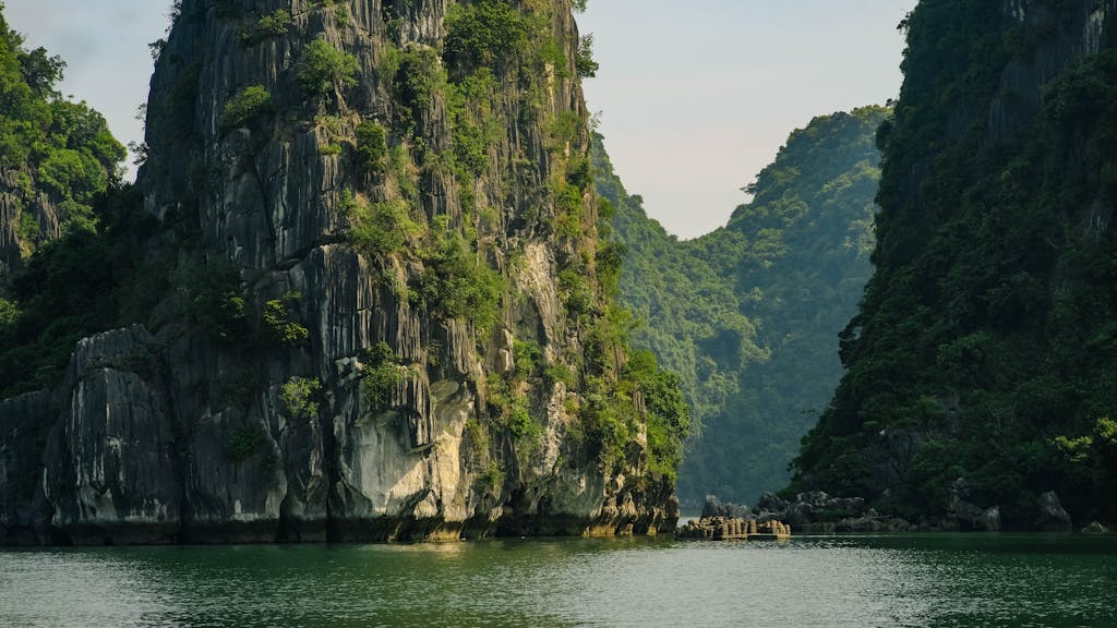 Breathtaking view of dramatic limestone cliffs and emerald waters in Halong Bay, Vietnam.