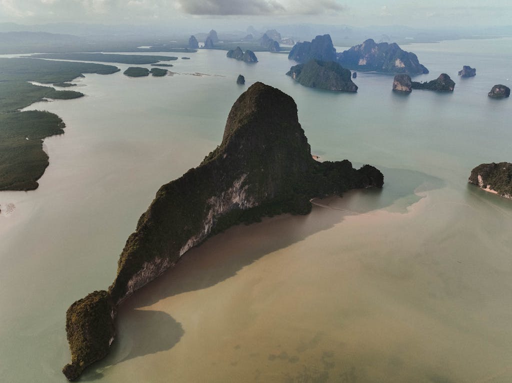 Explore the stunning karst formations of Phang Nga Bay, Thailand.