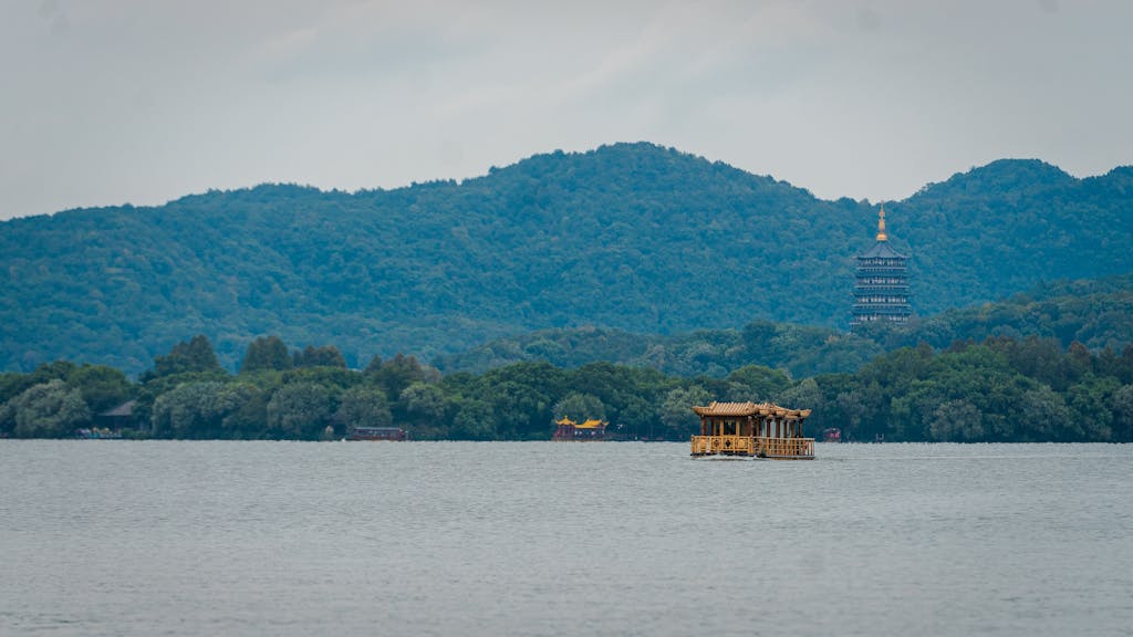 Picturesque view of West Lake with pagoda and boat, Hangzhou, China.