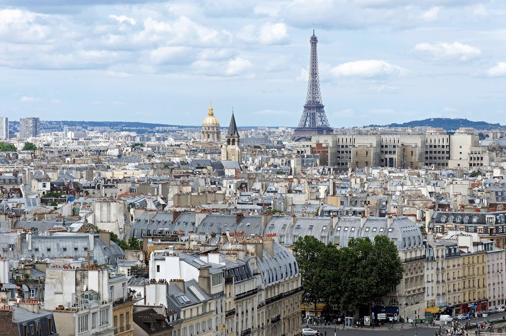 Stunning aerial shot of Paris cityscape featuring the iconic Eiffel Tower and historic architecture.