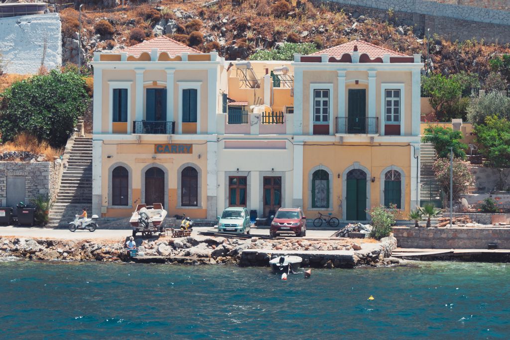 Charming waterfront houses in Ano Symi, Greece with a picturesque seaside view.